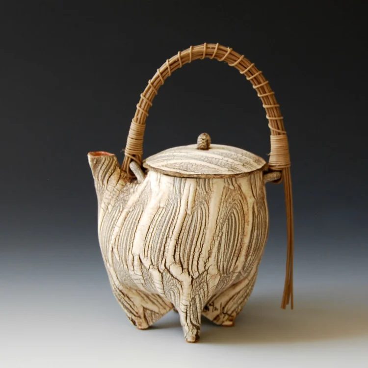 A teapot with a bamboo handle by Akira Satake