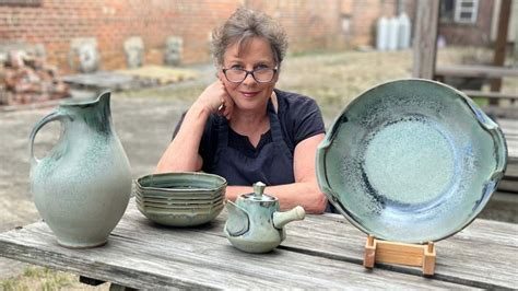 Sarah Wells Rolland with her celadon pitcher, bowls, teapot, and platter