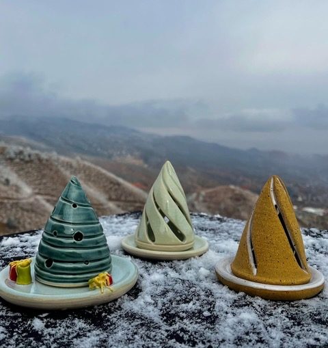 Three ceramic tree luminaries on snow